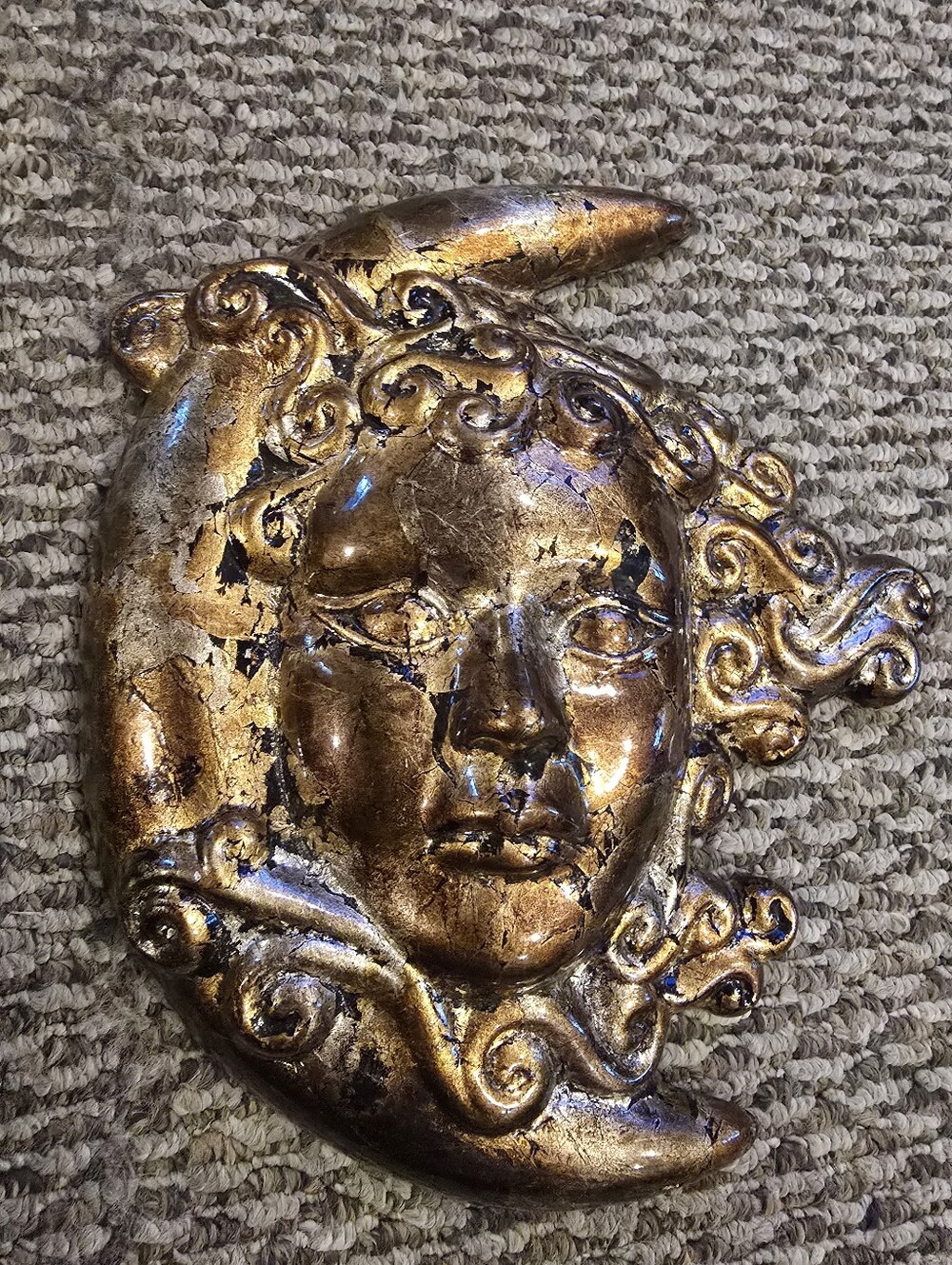 crescent moon wall plaque featuring a serene celestial face with flowing, ornate